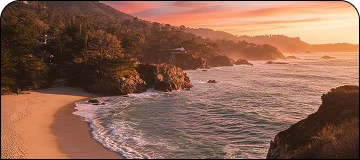 A scenic view of a rugged coastline at sunset, showing waves crashing onto a sandy beach bordered by rocky cliffs, trees, and dramatic hills.