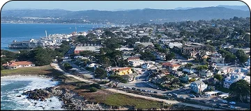 Aerial view of a Beach side city probably Monterey in daylight.