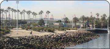 A waterfront scene of Long Beach with a sandy shore and distant skyline, capturing the maritime allure of Long Beach.