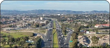 Scenic aerial view along the San Diego to Temecula route of vineyards and rolling hills with a highway.